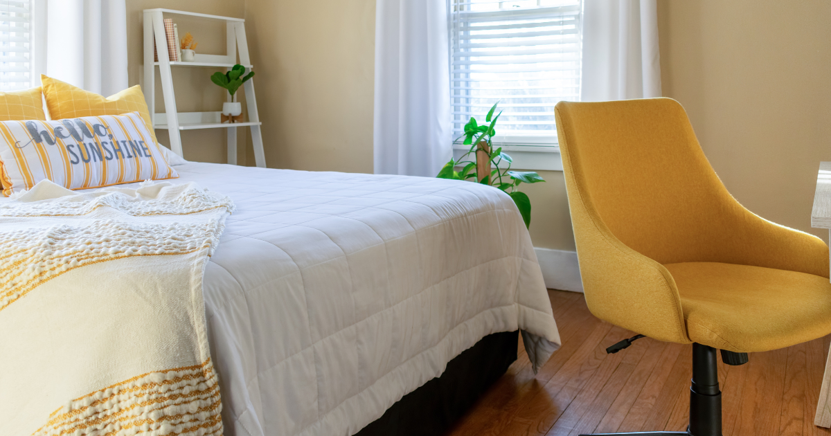 A clean and well-made bed in a short-term rental, showcasing the importance of Airbnb linen cleaning service for a positive guest experience.