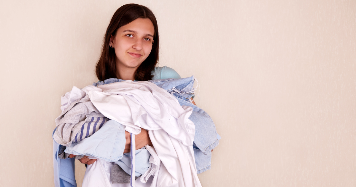 Laundry Service in Charlotte NC - The WashRoom Laundry Service A college student carries an armful of clothes to the laundry room without a college laundry bag or hamper.